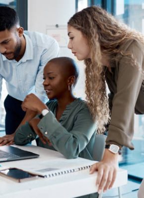 Team collaboration, online marketing and laptop planning for ideas, inspiration and strategy in startup company. Business people in diversity group working, meeting and discussion with internet tech